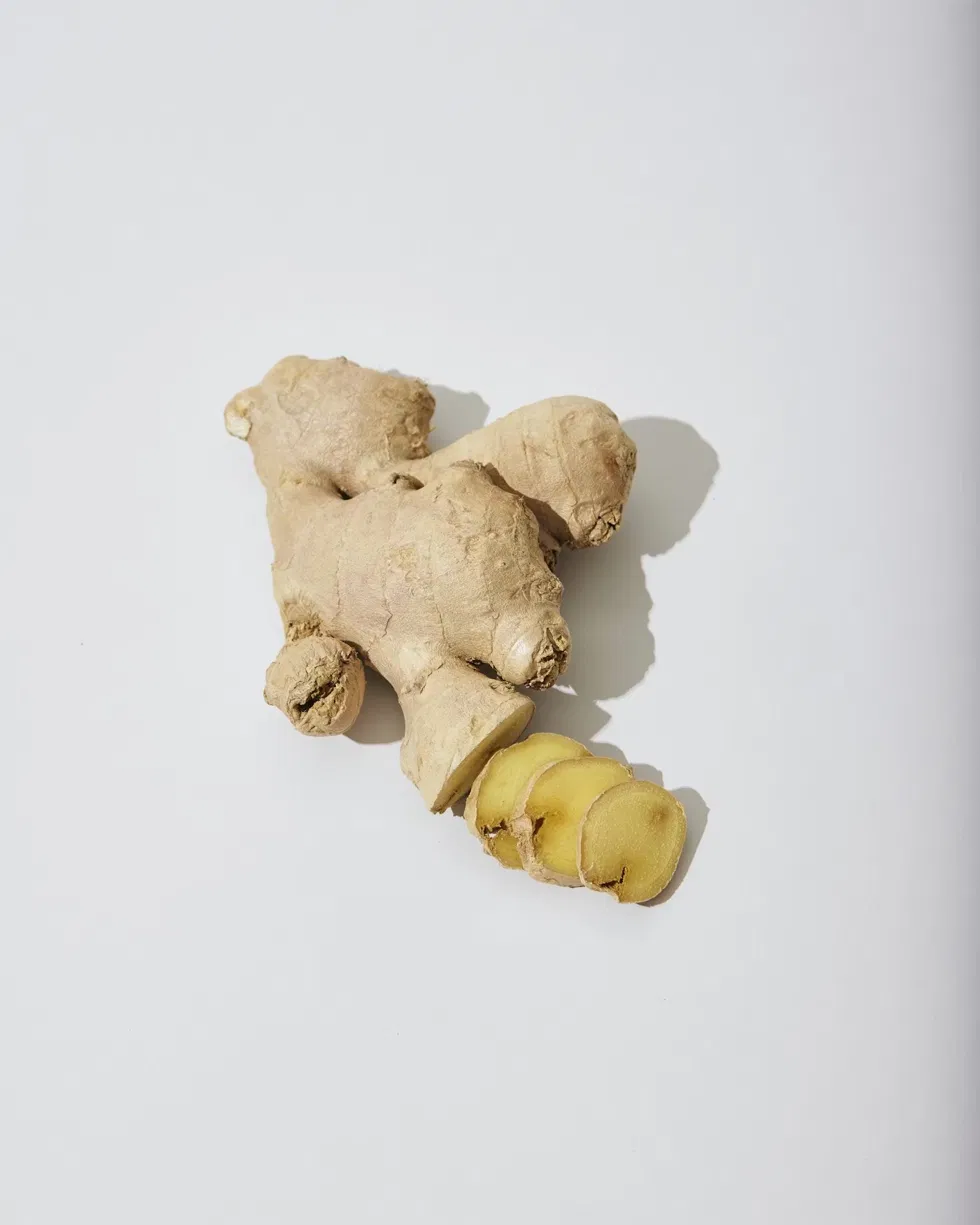 Fresh ginger root, whole and sliced